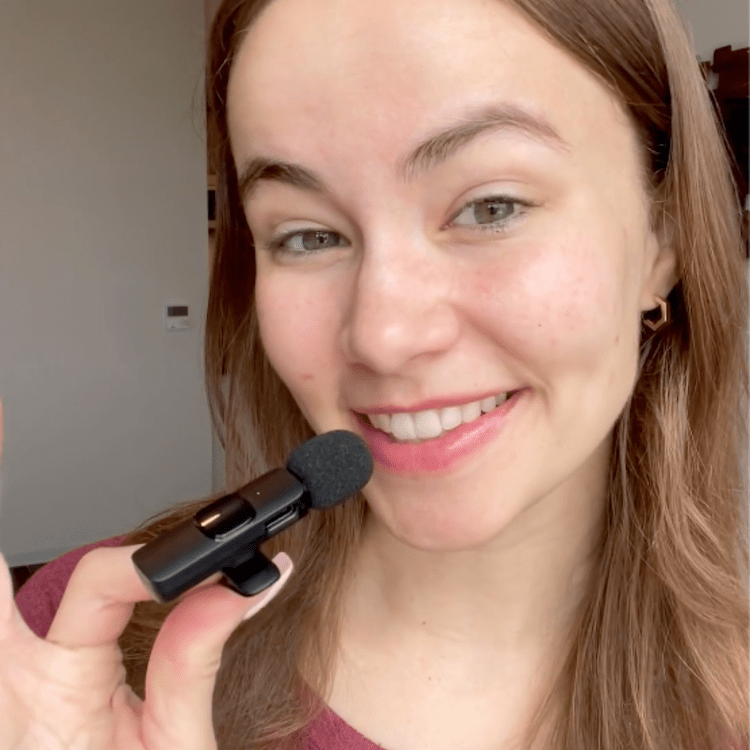 Women smiling and holding Magic Pop Microphone, black.